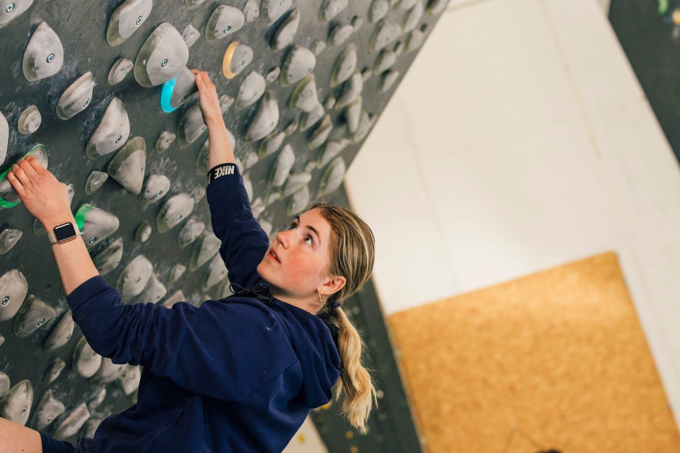 Child climbing a colourful bouldering wall